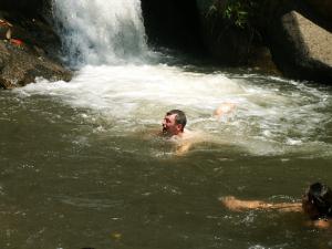 Swimming at waterfall in the mountains of