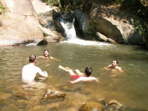 Swimming at waterfall in the mountains of