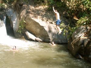 Swimming at waterfall in the mountains of